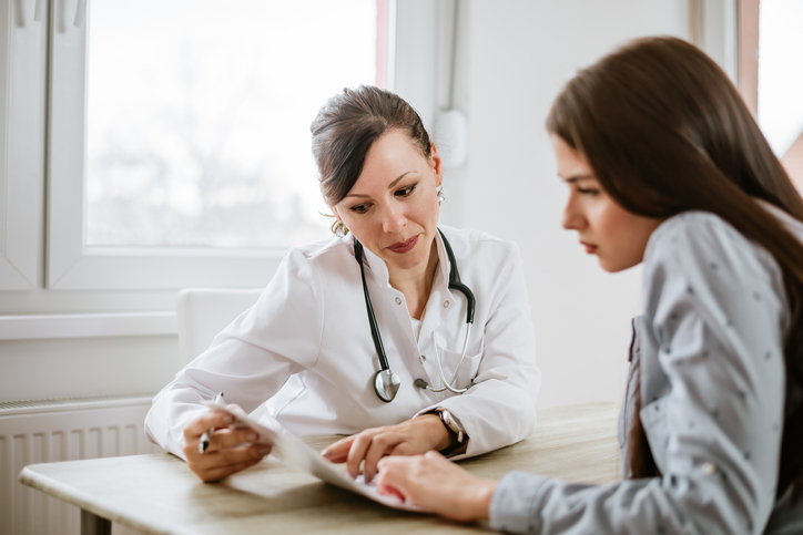 Doctor speaking with patient about the importance of annual gynecology exams.