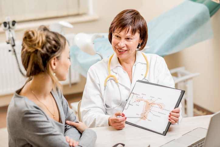 Young woman patient with a senior gynecologist during the consultation in the office, discussing hysterectomy..