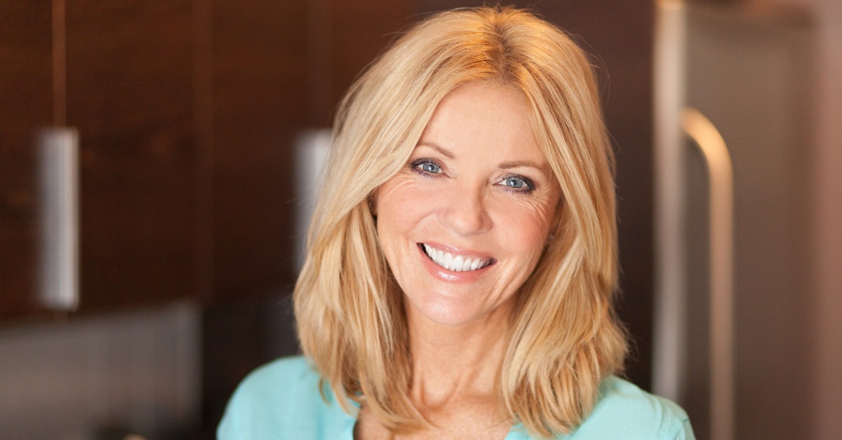 blond Caucasian menopausal woman smiling at health benefits of hormone pellets