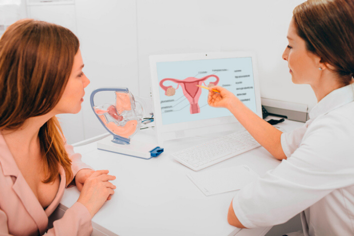 woman consults with her gynecologist in the gynecologist's office, discussing ovarian cysts.