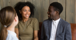 African American couple speaking with a doctor about infertility treatment options.