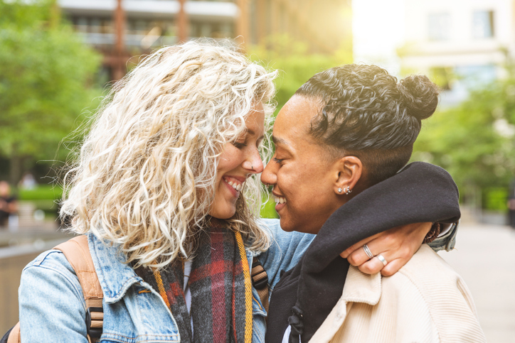 LGTBQIA couple holding hands, thinking about OBGYN Visits for the LGBTQIA Community.