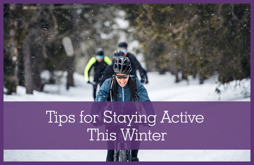 A group of young mountain bikers riding on road outdoors in winter, staying active this winter.