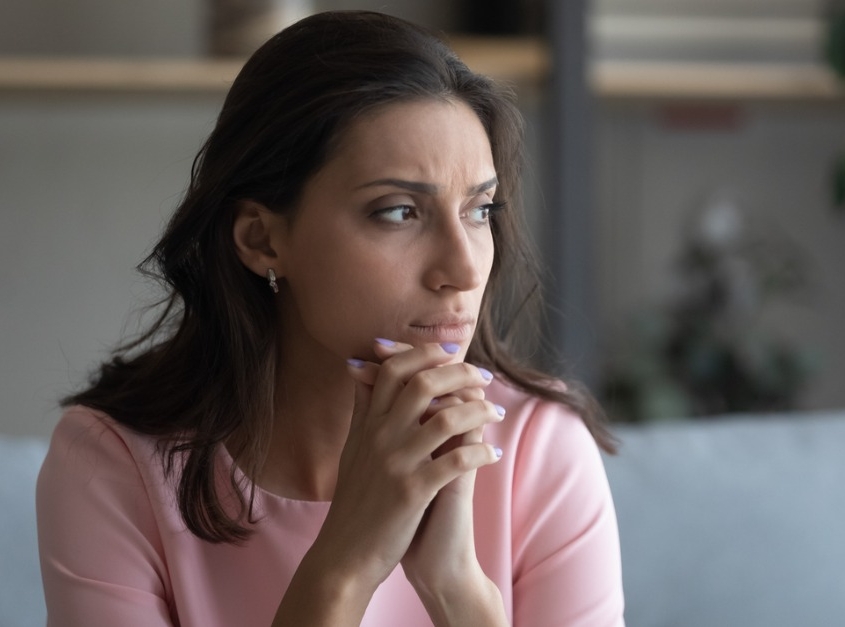 anxious woman thinking at home