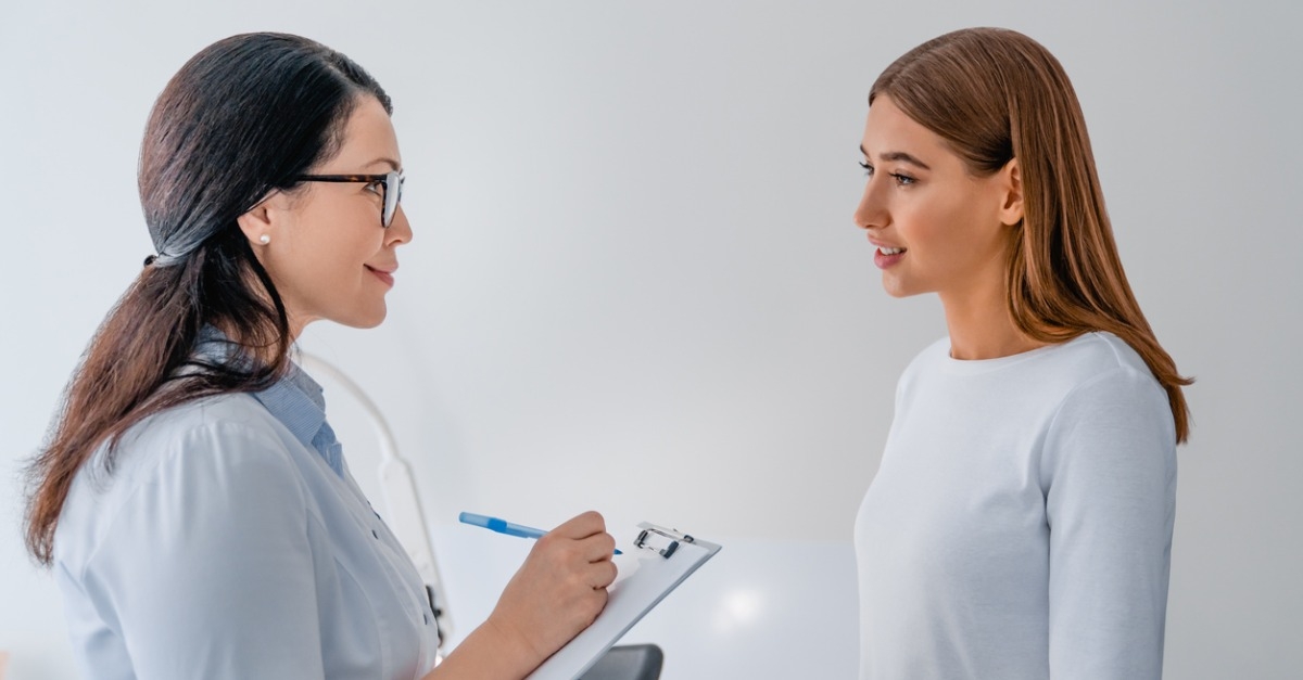 Female gynecologist working with patient