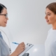 Female gynecologist working with patient