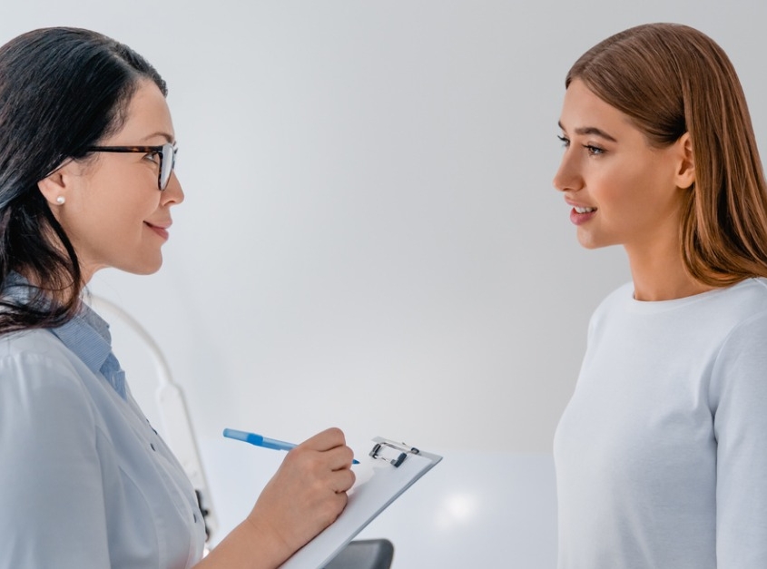 Female gynecologist working with patient