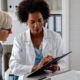 Female doctor showing female patient a clipboard