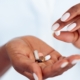 Woman hand holding pills