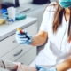 Female lab assistant holding test tube of blood