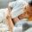Woman laying in bed with abdominal pain
