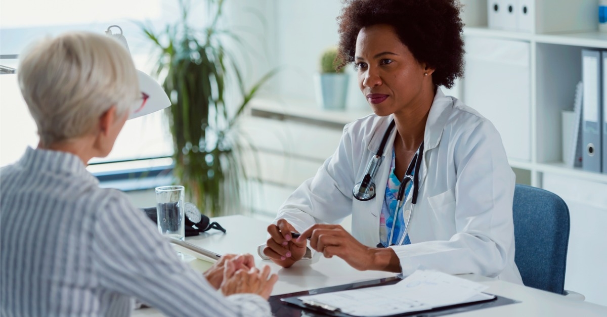 woman speaking with woman doctor