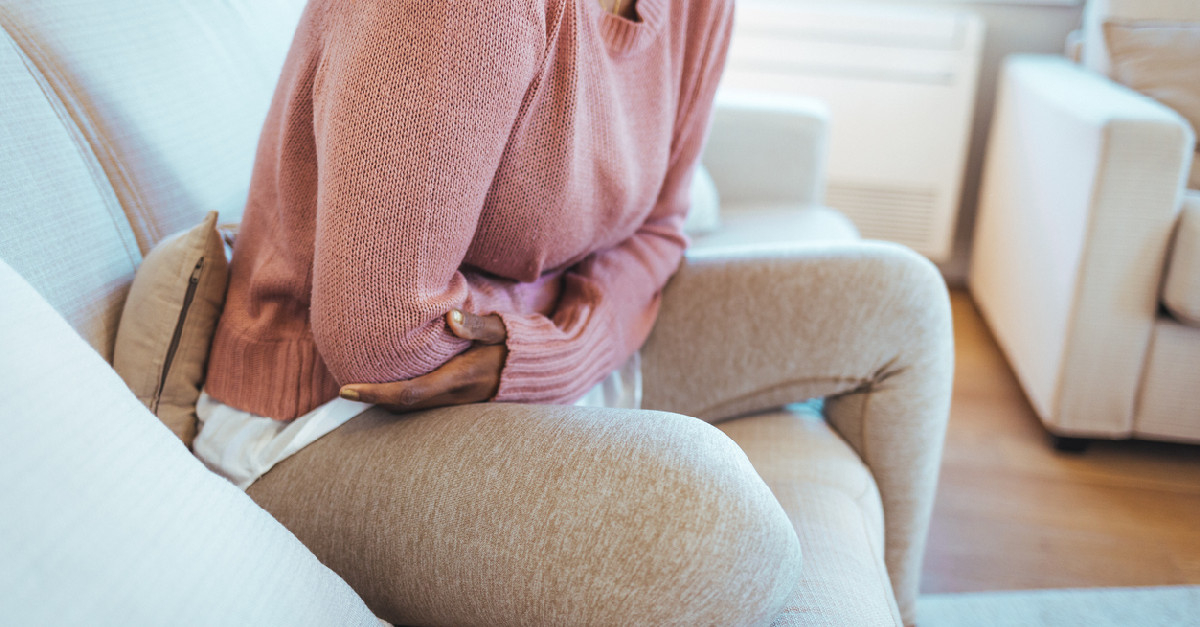 Woman holding stomach in pain