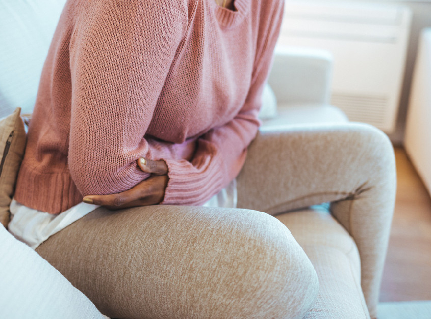 Woman holding stomach in pain