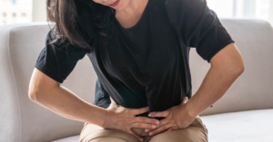 A lady experiencing abdominal pain from uterine cancer.