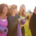 Group Of Mature Female Friends On Outdoor Yoga Retreat Walking Along Path Through Campsite