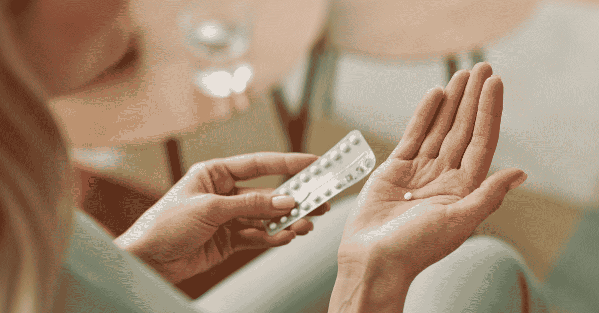 Close Up of Woman Taking Birth Control Pill stock photo